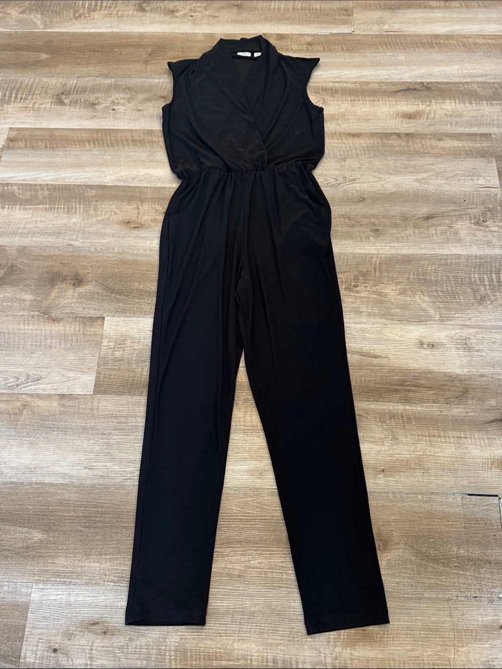 Cato sleeveless black jumpsuit featuring a surplice wrap-style front